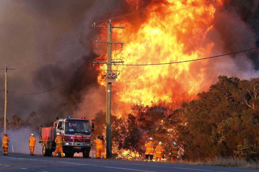 Fire-hit regions along the coast, such as near Salt Ash in the Hunter, may get some rain relief by next weekend. Photo: AAP