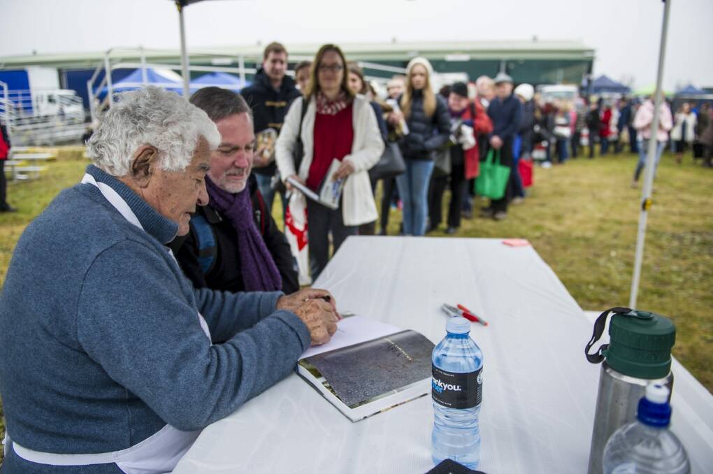 Fans young and old queue to have books signed by Italian chef Antonio Carluccio at the Capital Region Farmers Market in Canberra on Saturday.
 Photo: Jay Cronan