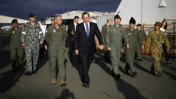 In step: Tony Abbott with Australian and international military personnel at RAAF Base Pearce during his Senate election campaign visit to Western Australia. Photo: AFP