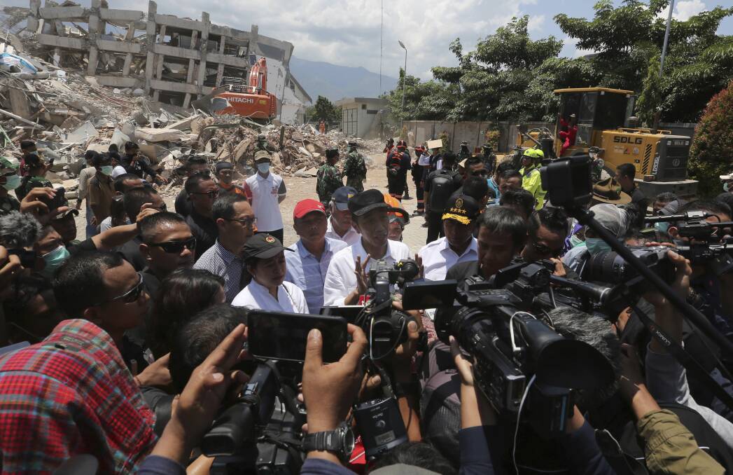 Indonesian President Joko Widodo, centre, after visiting  earthquake and tsunami-damaged Roa-Roa Hotel in Palu. Photo: AP