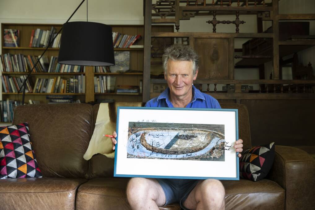 Braidwood farmer Martin Royds holds an artwork by John Wolseley depicting his moated dam concept. Photo: Sitthixay Ditthavong