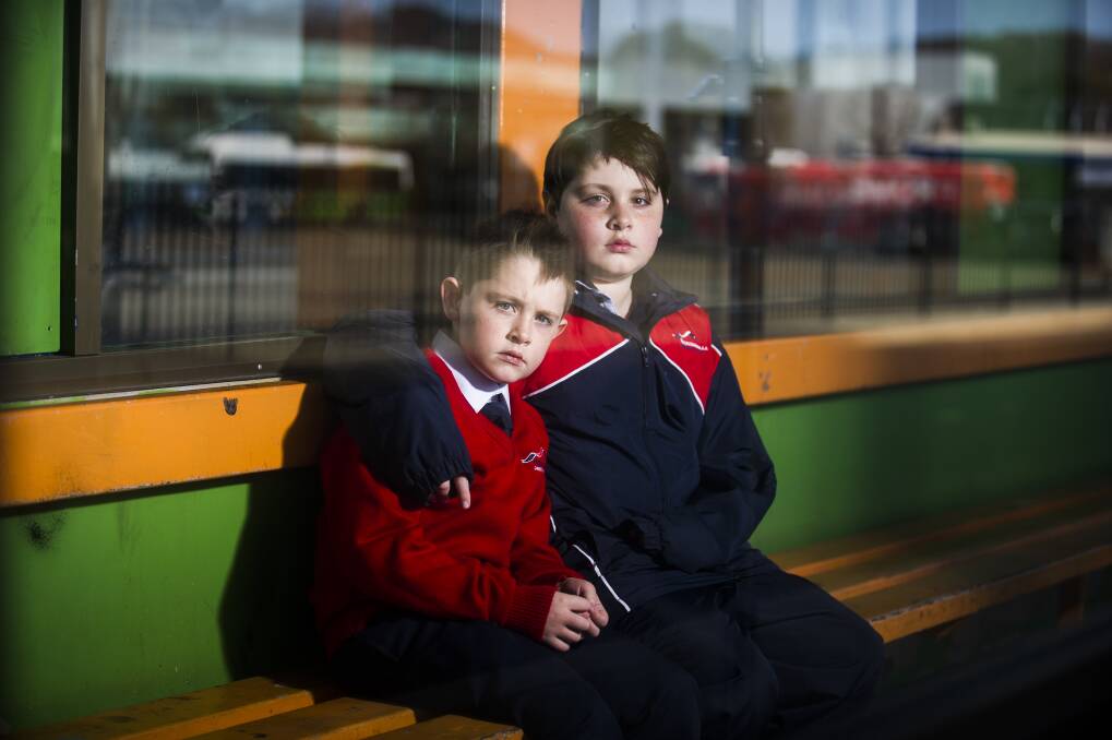 Elijah Sham, 7, and Noah Sham, 10, at the Woden Bus Interchange. Photo: Dion Georgopoulos