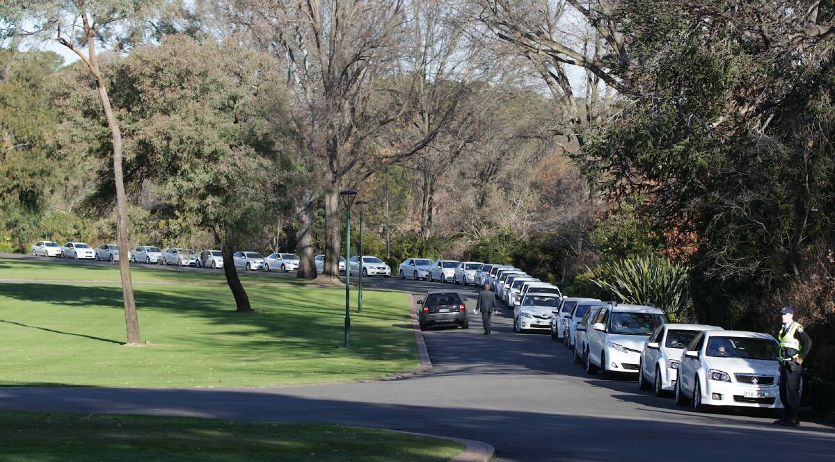 Comcars wait to pick-up the politicians after a swearing-in ceremony at Government House. Photo: Alex Ellinghausen 