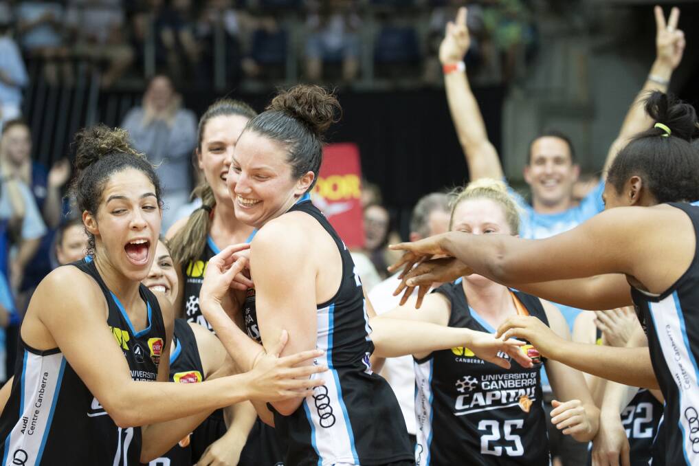 Canberra Capitals teammates cheer their co-captain Kelsey Griffin Photo: Sitthixay Ditthavong