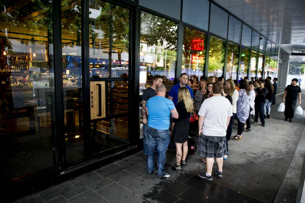 A queue of people waiting on Saturday night to take advantage of a promotional offer from new restaurant Akiba in the heart of Canberra. Photo: Jay Cronan