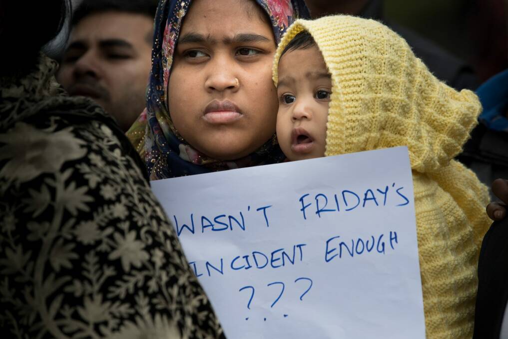 Families gather outside a refuge centre in Christchurch. Photo: Jason South