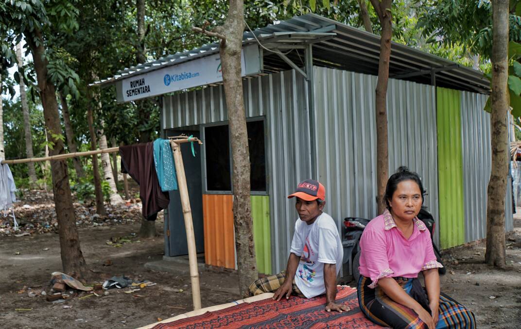 Ismail and his wife sitting in front of the temporary house built for them by an NGO. Photo: Amilia Rosa