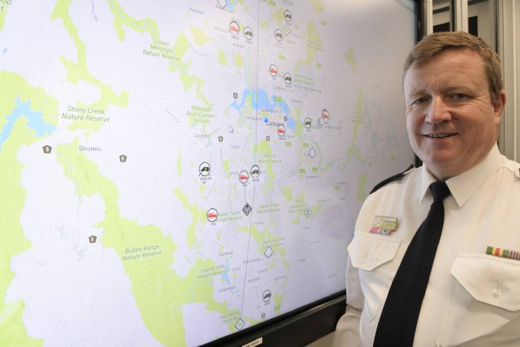 Emergency Services commissioner Dominic Lane next to a live map of incidents firefighters and paramedics are attending at the ESA headquarters in Fairbairn. Photo: Katie Burgess