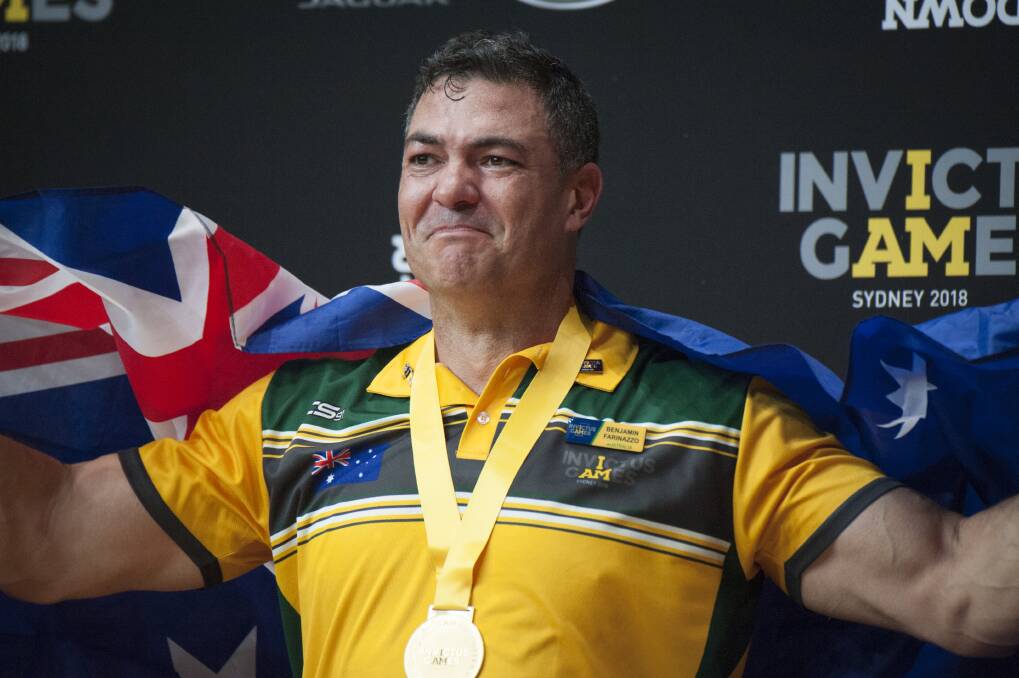 Ben  Farinazzo collects one of his two gold medals at the 2018 Invictus Games Photo: Michelle Kroll, UNSW Canberra