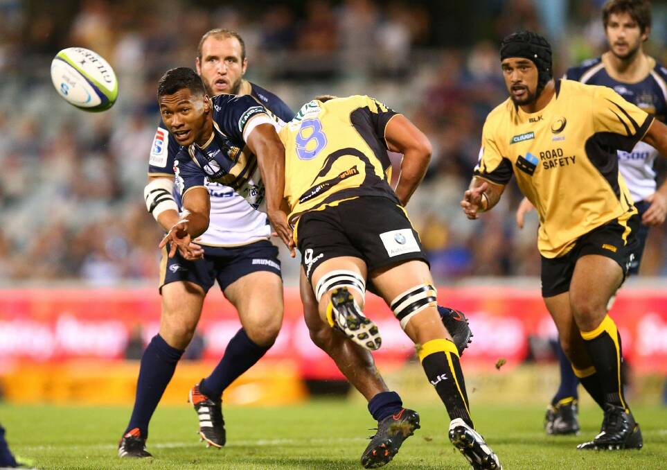 Offload: Aidan Toua gets the ball away under pressure from the Force defence. Photo: Getty Images