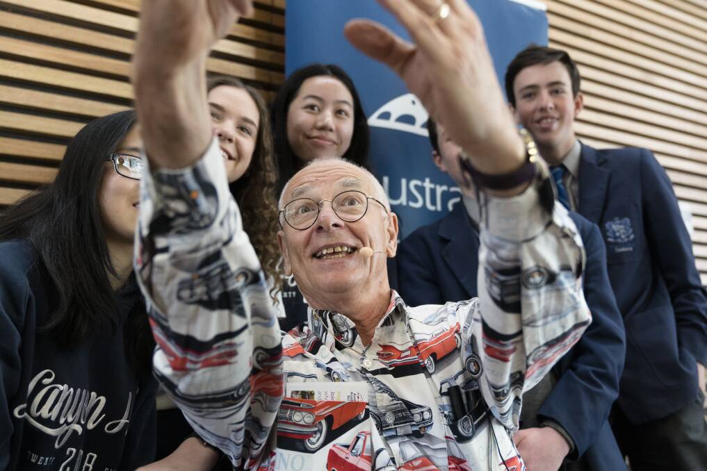 Dr Karl Kruszelnicki takes a selfie with students from Lanyon High School and Marist Collage on Friday. Photo: Lawrence Atkin