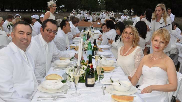 Michael Beacher, Elias Hallaj, Sandra Marie and Eleanor Flowers enjoy this year's Diner En Blanc in Canberra. Photo: Lyn Mills