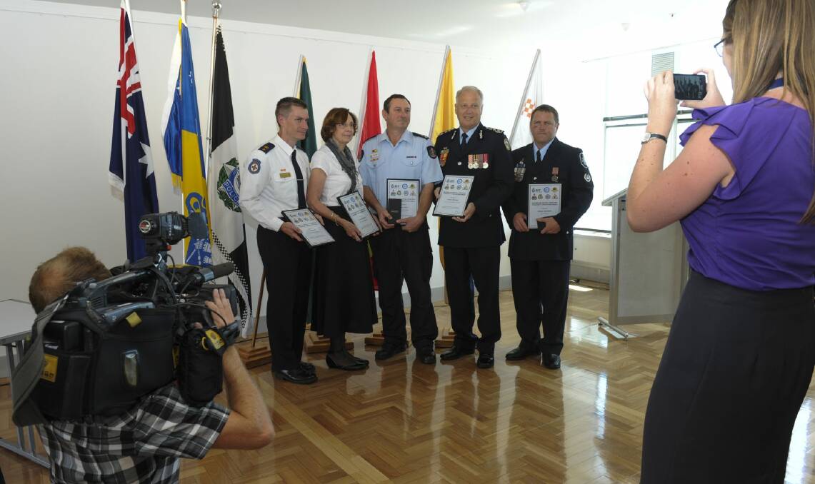 Five recipients of the ACT Community Protection Medal, from left, Toby Keene, ACT Ambulance Service, Pauline Wassall, ACT Rural Fire Service, Andrew Cahill, ACT Fire and Rescue, Tony Graham, ACT State Emergency Service and Station Sergeant Rodney Anderson, ACT Policing.  Photo: Graham Tidy