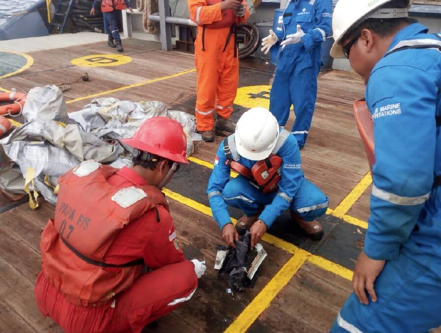 Recovery teams sift through debris believed to be from the crashed Lion Air flight.  Photo: Twitter: Sutopo_PN