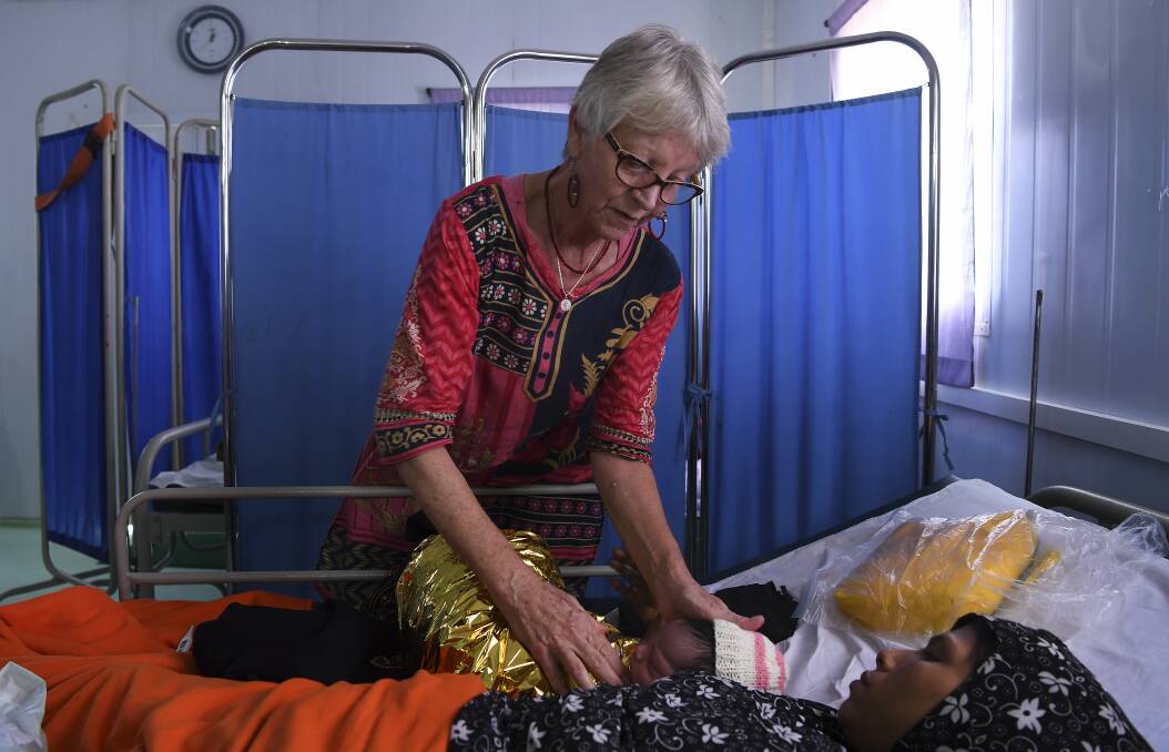 Kate Edmonds attends Fatima, 25, and her hours old baby at the Medecins Sans Frontieres hospital in Kutupalong Camp. Photo: Kate Geraghty