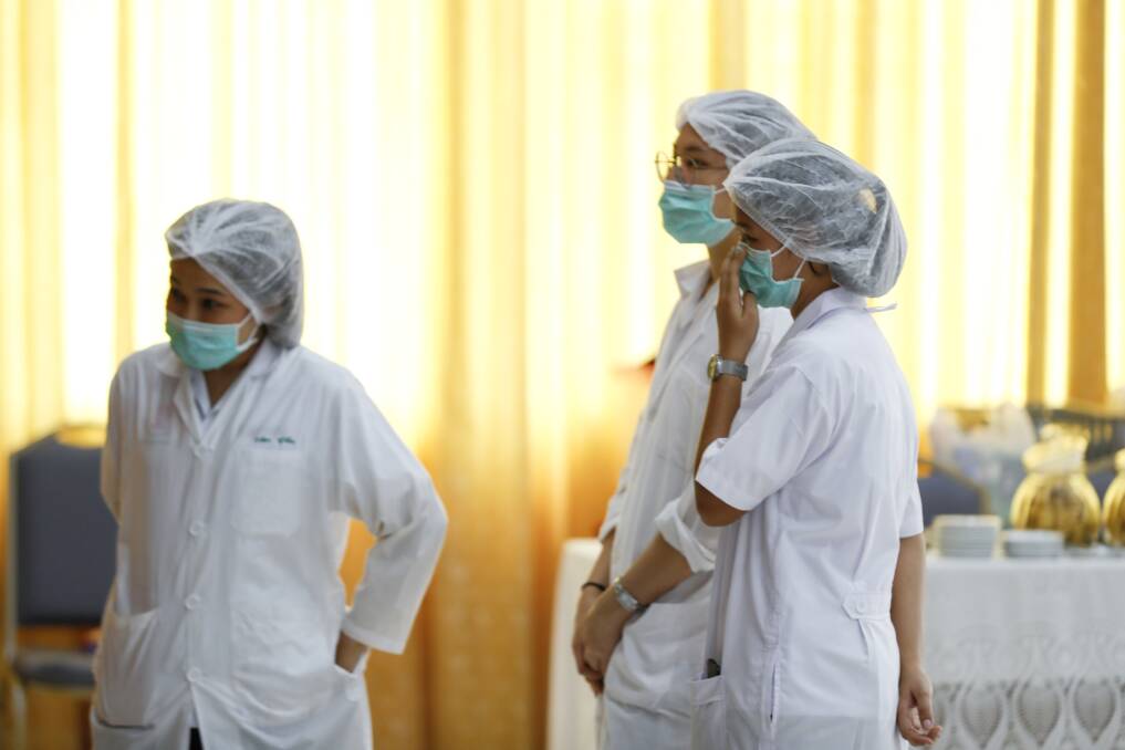 Hospital workers watch a press conference where the rescued boys are being treated. Photo: AP