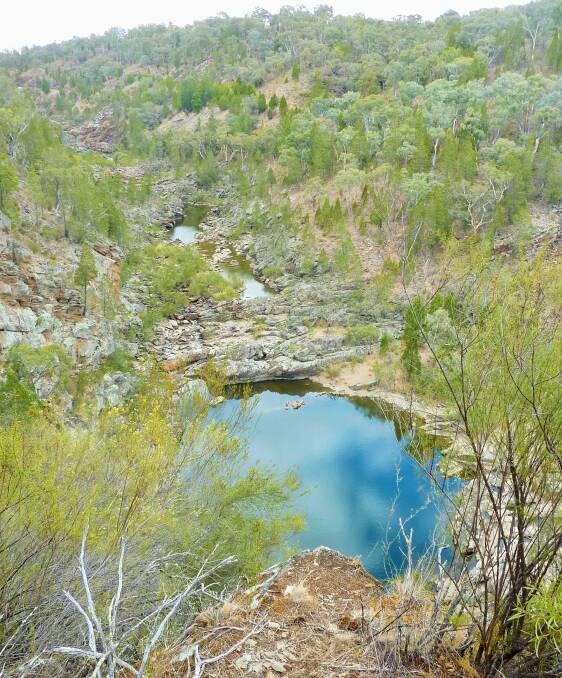 Blue sky reflects in a still pool of water in Molonglo Gorge. Photo: Tim the Yowie Man