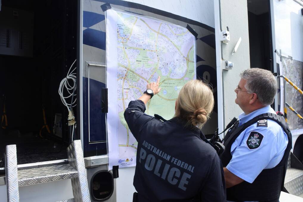 ACT emergency services look over a map as they coordinate a search for Ms Dennien. Photo: Supplied