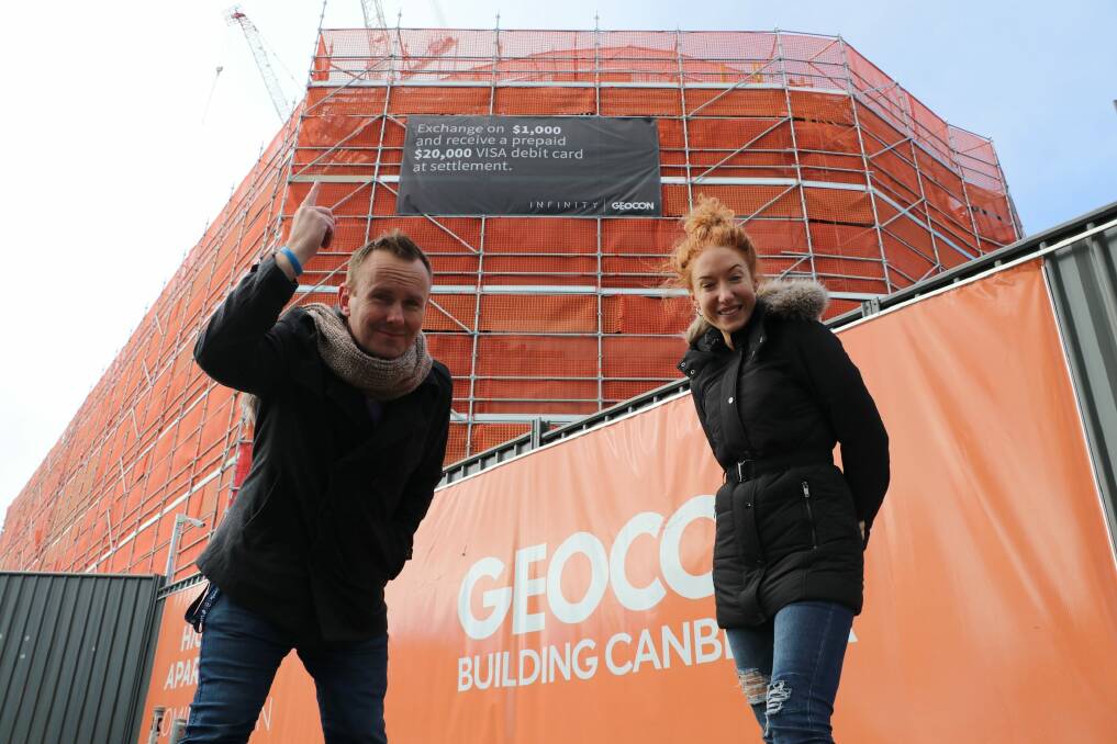 MIX 106.3's Kristen Henry  and Rod Cuddihy on-site at Geocon's Infinity Towers in Gungahlin where they will be dangling 100 metres in the air to raise money for sick kids at the Canberra Hospital. Photo: Supplied