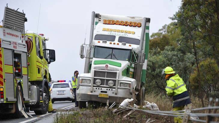 A truck that lost control on the Federal Highway northbound lanes, near the ACT/NSW border.  It damaged some safety fencing and spilled fuel on the road. Photo: Graham Tidy