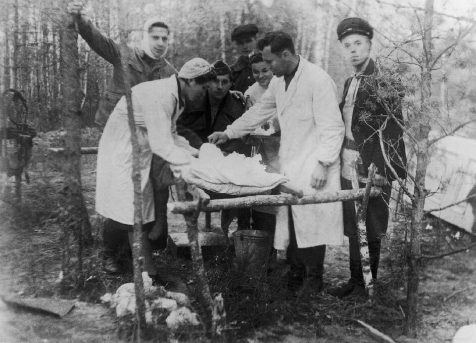 Jewish partisans tending to a wounded member of their group in the forest. Photo:  Supplied, courtesy Jewish Partisans Educational Foundation