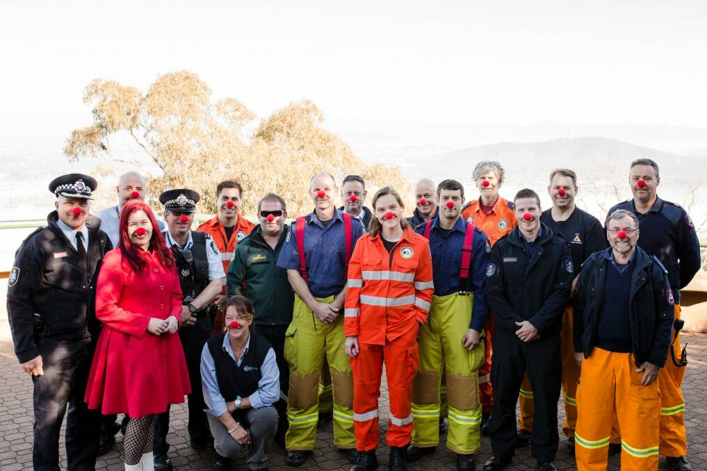At the top of Mount Ainslie on Wednesday, Canberra's emergency and transport services got into the spirit of Red Nose Day, which is Friday, June 30.  Photo: Jamila Toderas