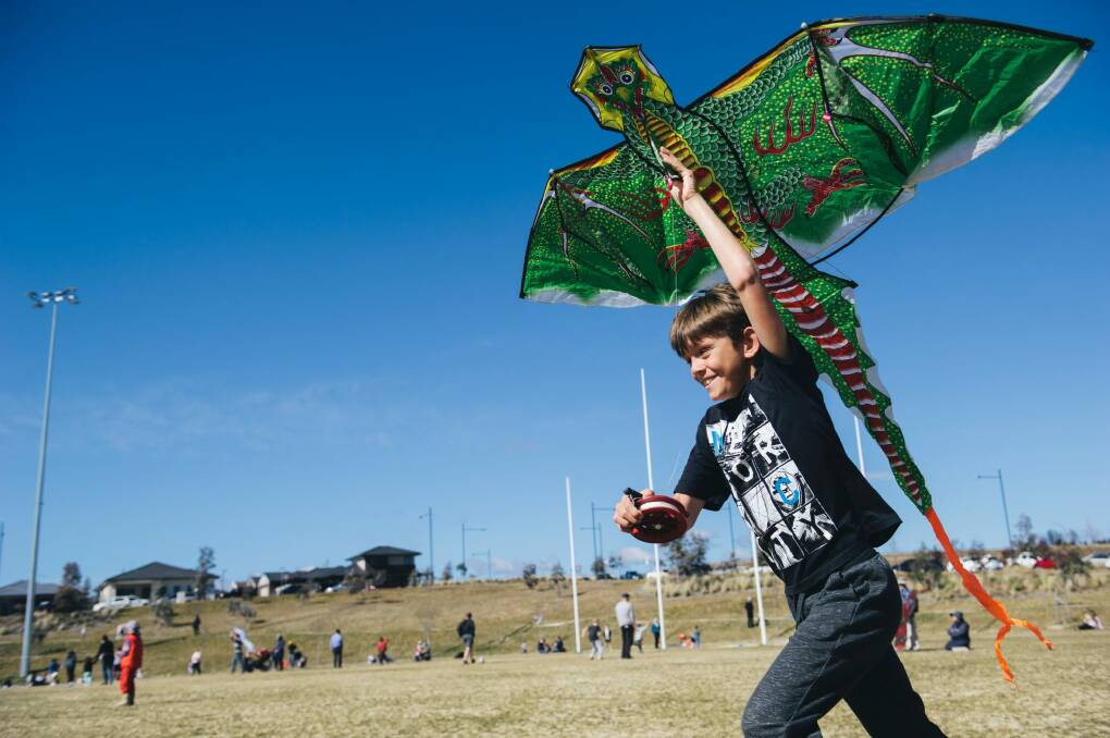 Macca Cleary, 9, of Queanbeyan trying to get his kite up despite a lack of wind at Flying High in the Googong Sky on Sunday morning. Photo: Rohan Thomson