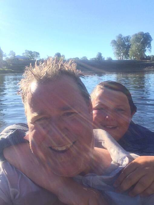 Adam Richards and son Ned cool off during their epic walk. Photo: Supplied