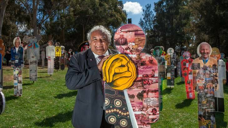 Dr Tom Calma stands next to his corflute replica. Photo: Katherine Griffiths