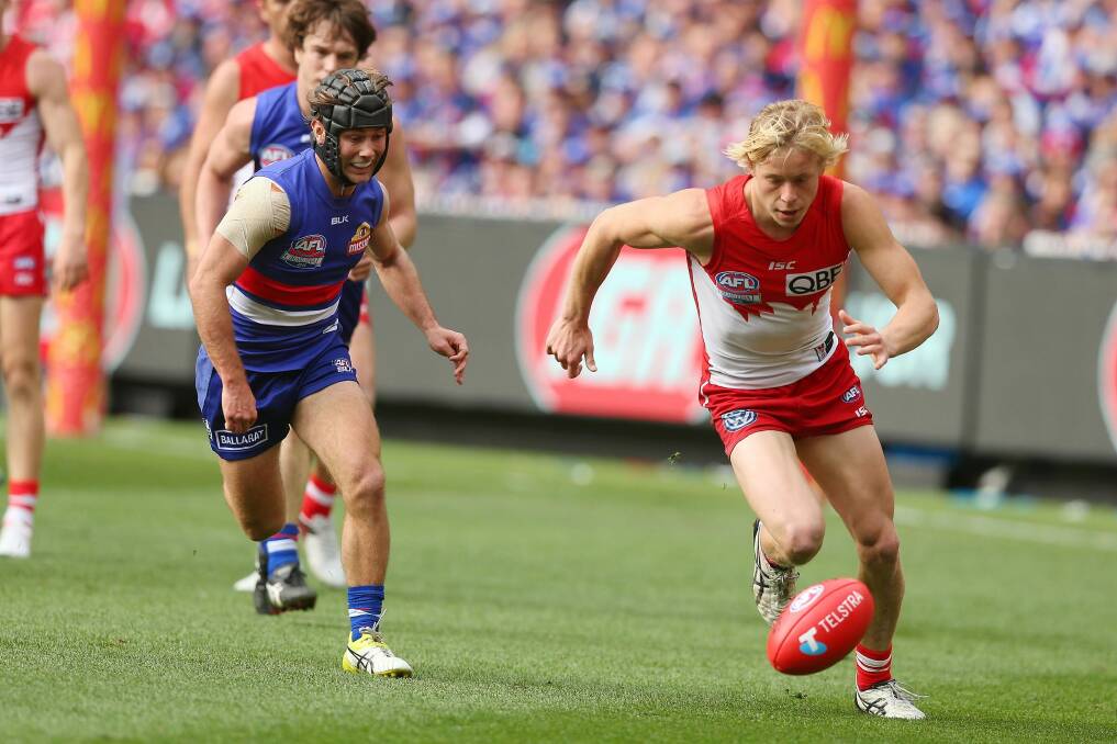 Breakout year: Isaac Heeney chases possession during the grand final against the Western Bulldogs. Photo: Graham Denholm