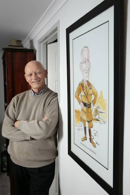 Legacy Canberra president Bill Rolfe pictured at home in Nicholls with a cartoon of him drawn by cartoonist Warren Brown that was gifted to him when he retired from the Repatriation Commission.     Photo: Jeffrey Chan