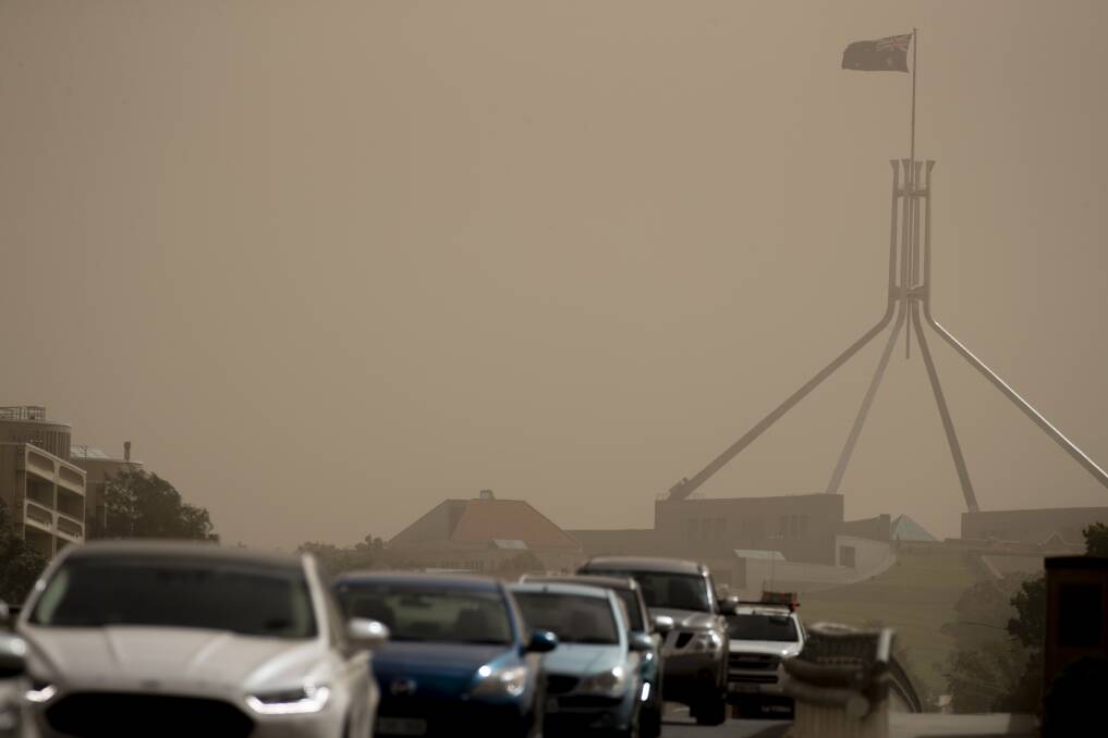 Strong winds blanket Parliament House in dust on Tuesday afternoon.  Photo: Sitthixay Ditthavong