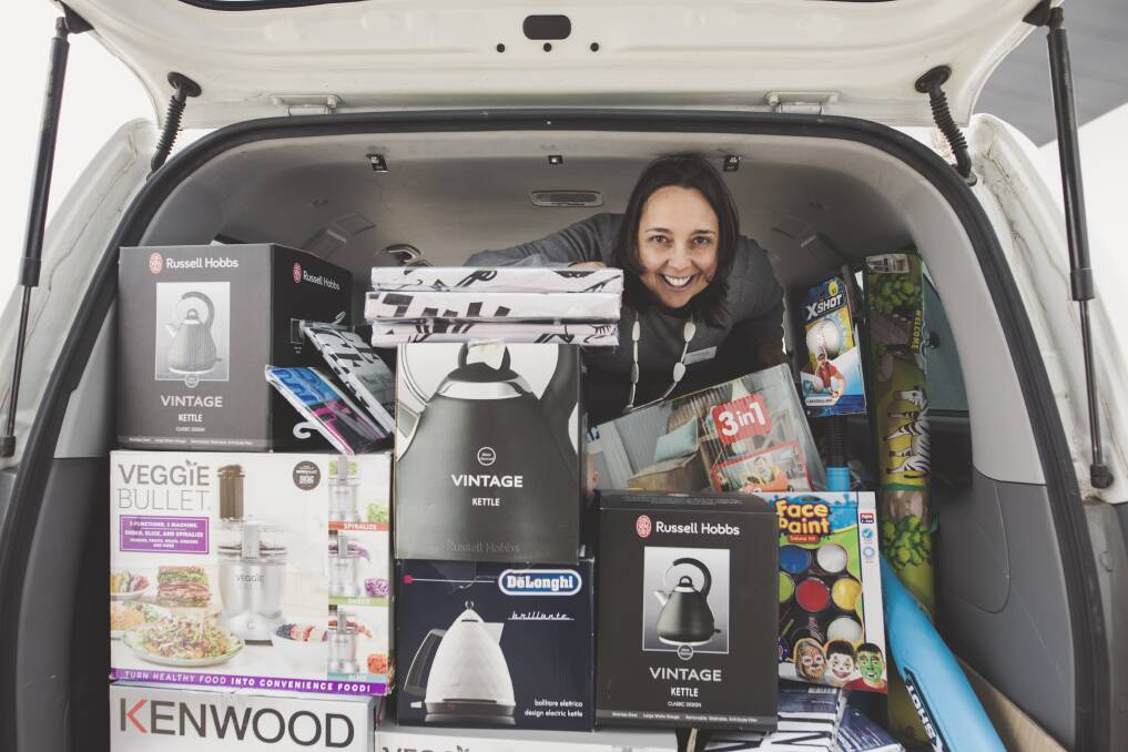 Karinya House property manager and senior caseworker Luisa Lopes with the donation from Big W Majura Park. Photo: Jamila Toderas
