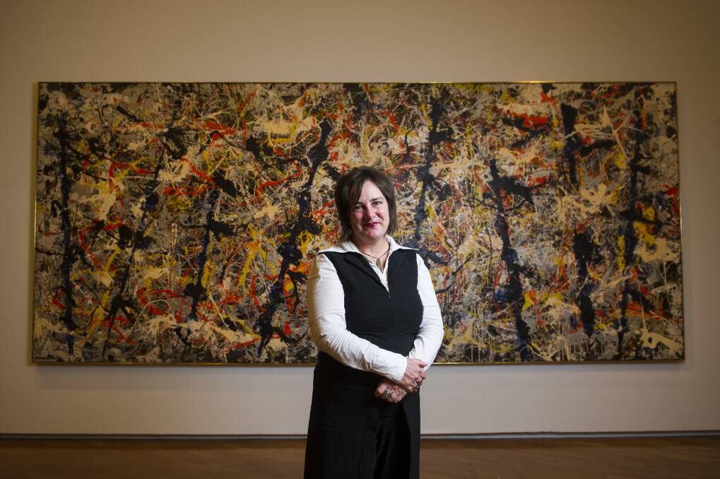 Senior Curator of International Art Lucina Ward in front of the Blue Poles.  Photo: Dion Georgopoulos