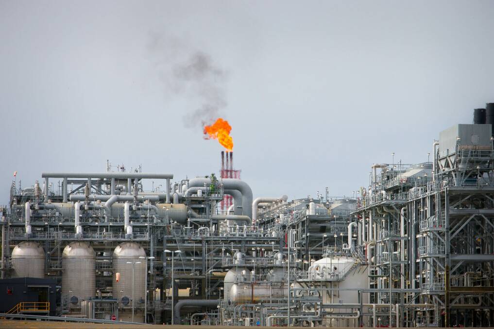 A flame blazes on top of flare stacks at a plant at the Queensland Curtis Liquefied Natural Gas Project. Photo: Bloomberg