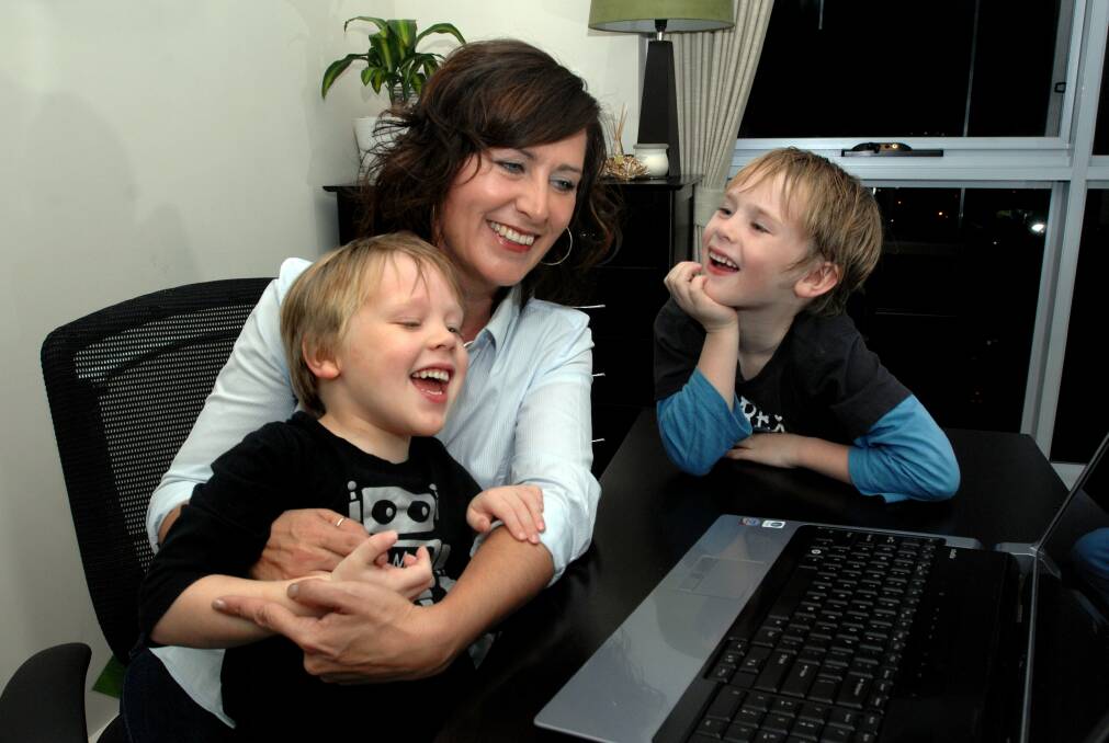 Laurie McDonald in 2009 with her sons Bailey, then four, and Connor, then six, when she won the ACT Business Woman of the Year award. Photo: Melissa Adams