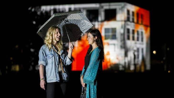 Emma Wild (28) and Hannah Purdy (25) in front of the questacon building on Saturday night at Enlighten. Photo: Rohan Thomson
