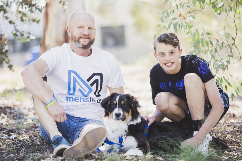 Peter "Cookie" Davis of Menslink with Lachlan Kelly Hammond, 16, and his soon-to-be assistance dog Koda. Photo: Jamila Toderas