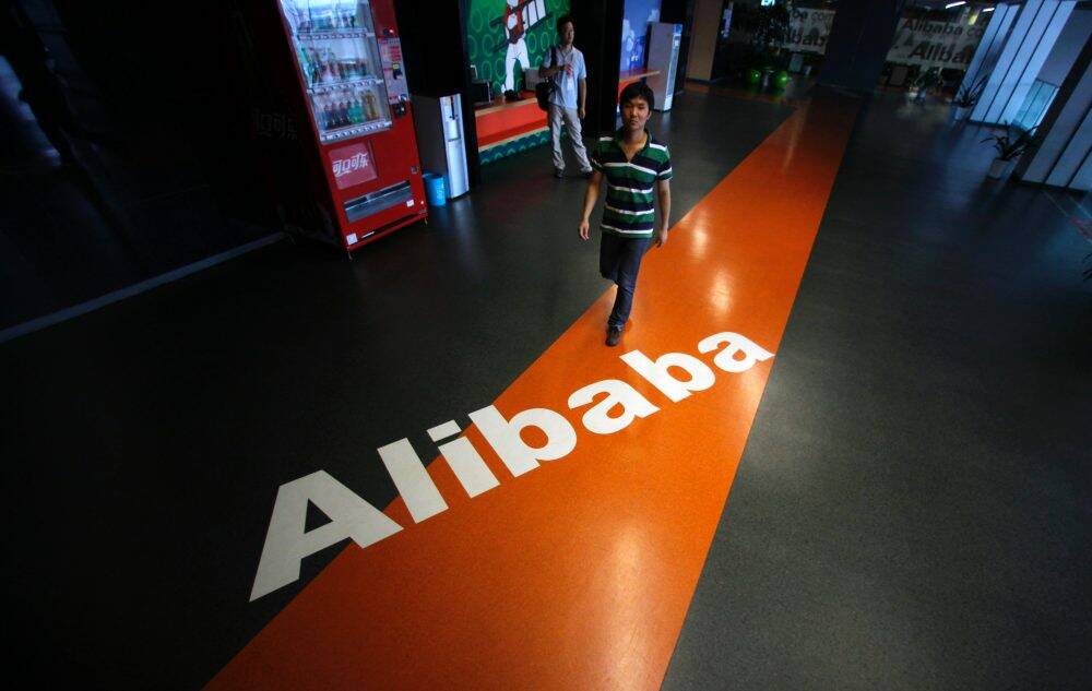 An employee walks past a logo of Alibaba at the company's headquarters in Hangzhou, Zhejiang province, China. Photo: Reuters