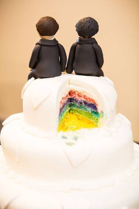 The rainbow cake made by Erindale Bakery and the two-groom cake topper created by Nada's cakes. Photo: Same Love Photography