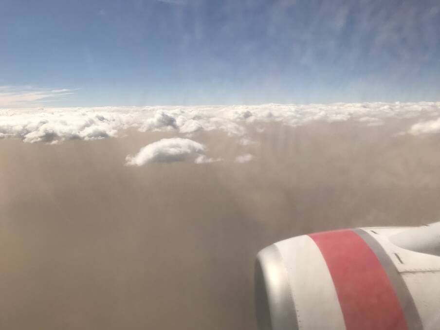 The dust storm over Canberra from a Virgin Australia flight, which had to abort its first landing attempt on Tuesday afternoon because of wind.  Photo: Sarah Curby