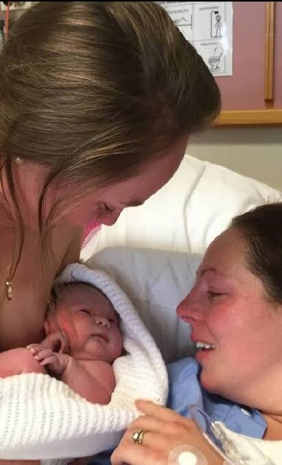 The emotional moment when baby Ruby Wigg was born. Kate Wigg, of Jerrabomberra, with her sister Emma Fowler, of Bonython, who acted as her surrogate. Photo: Supplied