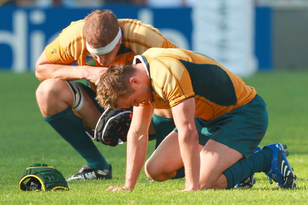 Down and out: Matt Giteau  (right) and Dan Vickerman show their despair after the Wallabies lost their World Cup quarter-final against England in 2007. Photo: AP