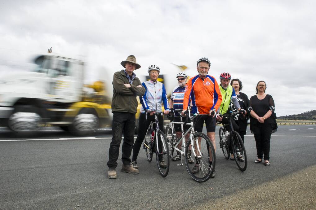 Residents Ross Hampton and Pauline Thorn, cyclists Peter Granleese and Glenn Cocking, John Thorn, Susan Butt and Wendy O'Dea, who are calling for cycle lanes to be included in plans for the Barton Highway duplication. Photo: Dion Georgopoulos