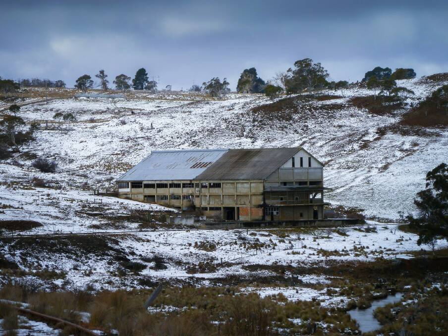 The old Bombala Railway line passes the derelict Maclaughlin Meat Works, photographed after a light snow fall. Photo: Judy Goggin