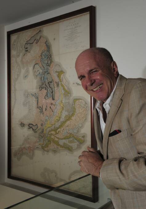Out there:  British author Simon Winchester, with a surviving copy of the 1815
geological map drawn by William Smith.   Photo:  Graham Tidy