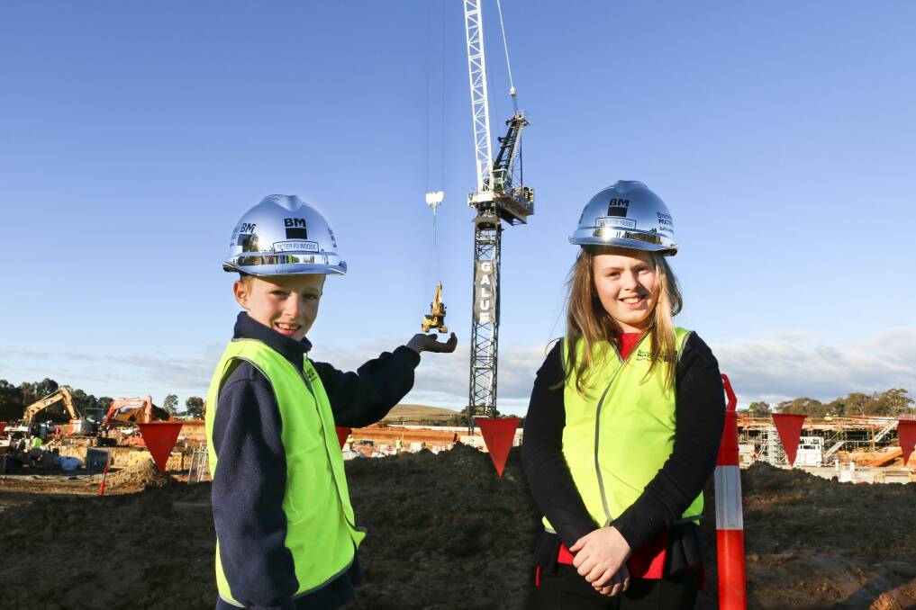 Peter ''PJ'' Woods, 7, and Charlotte Young, 10, won a competition to name the crane building the University of Canberra Public Hospital. Photo: Belle Thompson, ACT Health