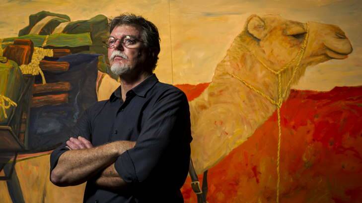 Archaeologist Dr Mike Smith with a painting of Morgan the camel, which he has taken on trips through the Australian desert. Photo: Rohan Thomson