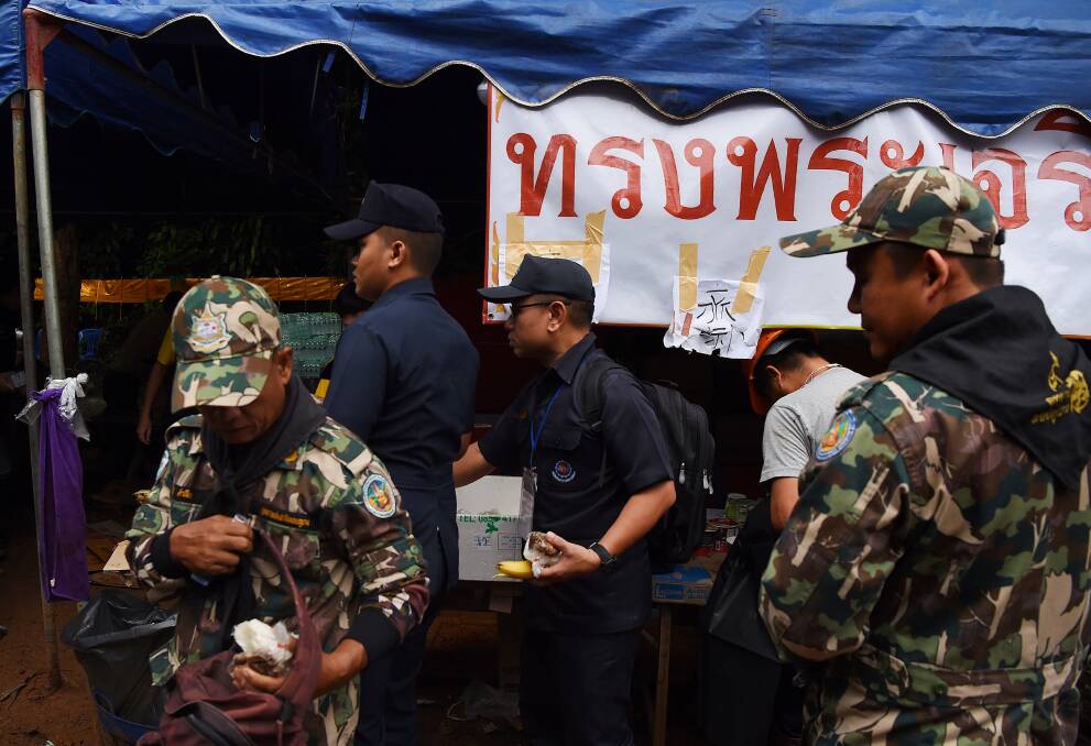 Thai rescuers collect food at the base camp at Tham Luang Cave. Photo: Kate Geraghty