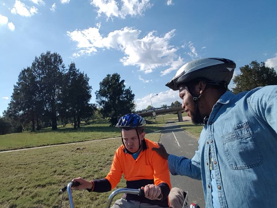 Hartley Lifecare client Cameron Smith, with his support worker  Aloysius, will ride the last kilometre of the Hartley Cycle Challenge with the leading team. Photo: Supplied